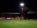 Players from both sides take a knee for the Black Lives Matter movement prior to the EFL Trophy match between Leyton Orient and AFC Wimbledon.