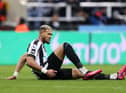 Newcastle United midfielder Joelinton goes down needing treatment against Liverpool.