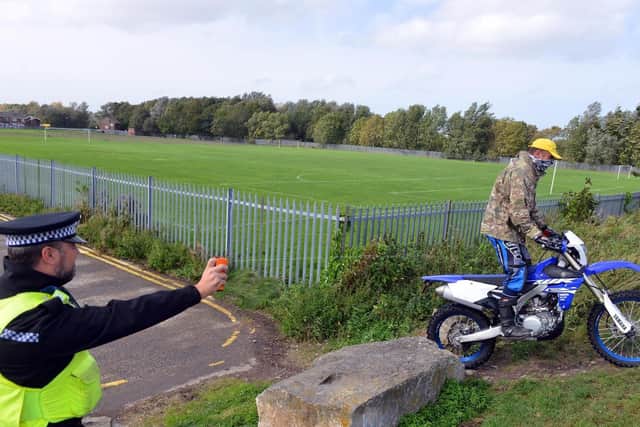 A picture posed by Northumbria Police of an officer tackling a problem rider. The force has previously tried variety of tactics to clamp down on nuisance riders, including so-called 'DNA spray'.