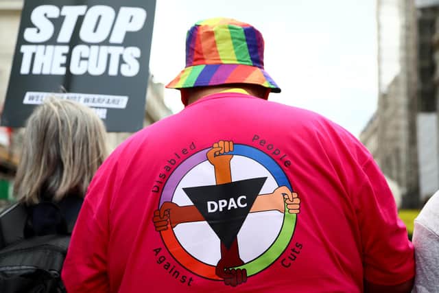 An activist wearing a t-shirt against disability benefit cuts during a protest over proposed cuts organised by the People's Assembly earlier this month in London. Photo by Alishia Abodunde/Getty Images