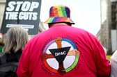 An activist wearing a t-shirt against disability benefit cuts during a protest over proposed cuts organised by the People's Assembly earlier this month in London. Photo by Alishia Abodunde/Getty Images