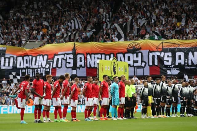 The players line up against the backdrop of a Wor Flags banner.