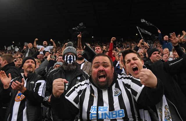 Newcastle fans in the Gallowgate End celebrate the opening goal scored by Callum Wilson during the Premier League match between Newcastle United and Tottenham Hotspur at St. James Park on October 17, 2021 in Newcastle upon Tyne, England. (Photo by Stu Forster/Getty Images)