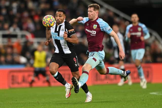 Newcastle player Callum Wilson is fouled by Burnley defender Nathan Collins during the Premier League match between Newcastle United and Burnley at St. James Park on December 04, 2021 in Newcastle upon Tyne, England. (Photo by Stu Forster/Getty Images)