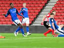 Denver Hume slides home Sunderland's second goal against Carlisle United