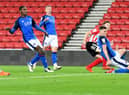 Denver Hume slides home Sunderland's second goal against Carlisle United