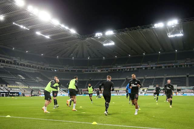 NEWCASTLE UPON TYNE, ENGLAND - DECEMBER 19:  General view inside the stadium as Callum Wilson of Newcastle United warms up prior to the Premier League match between Newcastle United and Fulham at St. James Park on December 19, 2020 in Newcastle upon Tyne, England. The match will be played without fans, behind closed doors as a Covid-19 precaution. (Photo by Alex Pantling/Getty Images)