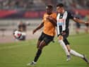 Newcastle United's Kelland Watts (R) fights for the ball with Wolverhampton Wanderers's Niall Ennis (R) during the 2019 Premier League Asia Trophy football tournament in Nanjing, in China's Jiangsu province on July 17, 2019.