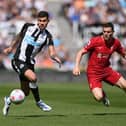 Bruno Guimaraes of Newcastle United is challenged by James Milner of Liverpool during the Premier League match between Newcastle United and Liverpool at St. James Park on April 30, 2022 in Newcastle upon Tyne, England. (Photo by Stu Forster/Getty Images)