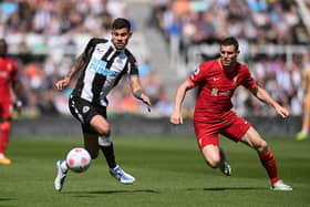 Bruno Guimaraes of Newcastle United is challenged by James Milner of Liverpool during the Premier League match between Newcastle United and Liverpool at St. James Park on April 30, 2022 in Newcastle upon Tyne, England. (Photo by Stu Forster/Getty Images)