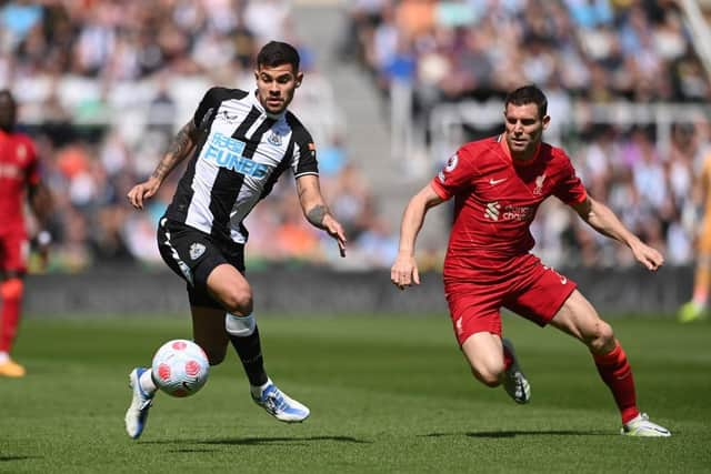 Bruno Guimaraes of Newcastle United is challenged by James Milner of Liverpool during the Premier League match between Newcastle United and Liverpool at St. James Park on April 30, 2022 in Newcastle upon Tyne, England. (Photo by Stu Forster/Getty Images)