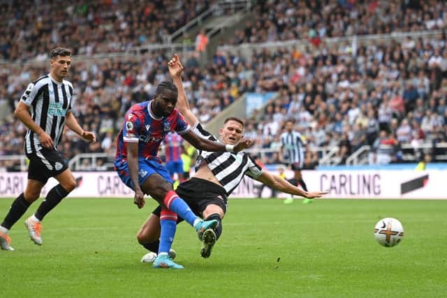 Newcastle player Sven Botman challenges Crystal Palace striker Odsonne Edouard who gets a shot in at goal during the Premier League match between Newcastle United and Crystal Palace at St. James Park on September 03, 2022 in Newcastle upon Tyne, England. (Photo by Stu Forster/Getty Images)