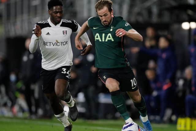 Harry Kane of Tottenham Hotspur is challenged by Ola Aina of Fulham during the Premier League match between Fulham and Tottenham Hotspur.