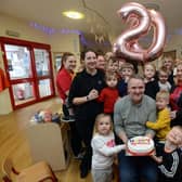 Early Learning Partnership nursery founder Eamonn Gribben celebrates with staff and nursery children.