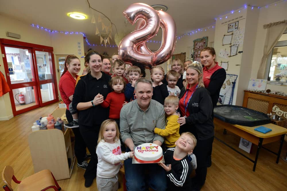 Early Learning Partnership nursery founder Eamonn Gribben celebrates with staff and nursery children.