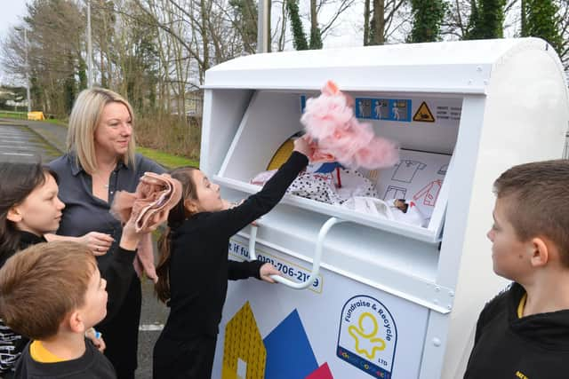 Fatfield Academy Inspires Deputy Headteacher Nicky Dowdle with members of the Eco Warrior team donating items at the new clothing recycling station.