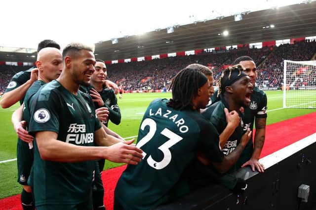 Allan Saint-Maximin is mobbed by his team-mates after scoring.