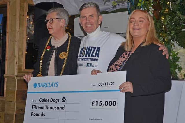 Carl presenting his cheque