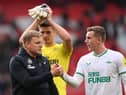 Eddie Howe, Manager of Newcastle United, shakes hands with Matt Targett of Newcastle United following the Premier League match between Manchester United and Newcastle United at Old Trafford on October 16, 2022 in Manchester, England. (Photo by Stu Forster/Getty Images)