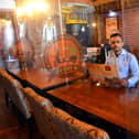 Delhi 6 owner Shah Lalon Amin inside the Ocean Road restaurant which features Covid-19 safety measures such as plastic screens between tables.