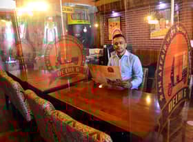Delhi 6 owner Shah Lalon Amin inside the Ocean Road restaurant which features Covid-19 safety measures such as plastic screens between tables.