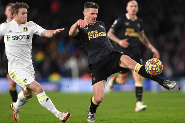 Newcastle defender Ciaran Clark (r) clears under pressure from Joe Gelhardt of Leeds during the Premier League match between Leeds United and Newcastle United at Elland Road on January 22, 2022 in Leeds, England. (Photo by Stu Forster/Getty Images)