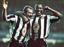 Newcastle strikers Alan Shearer (l) and Les Ferdinand celebrate the fourth goal scored by Shearer during the Premier League match between Newcastle United and Manchester United at St Jame's Park on October 20, 1996 in Newcastle, England, Newcastle won the game 5-0. (Photo by Ben Radford/Allsport/Getty Images/Hulton Archive)