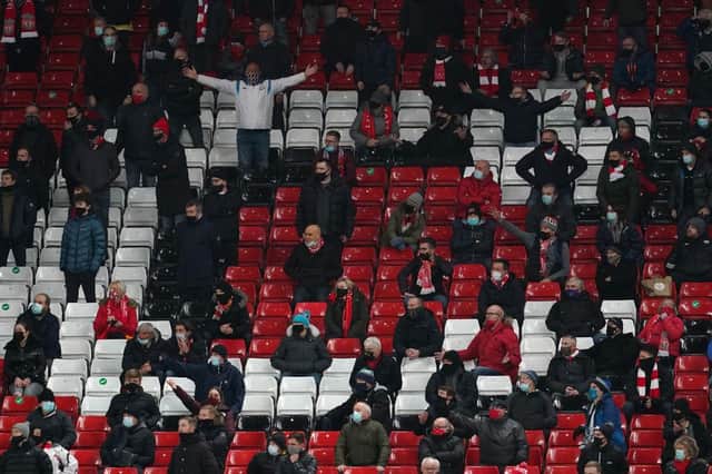 Fans react during the Premier League match between Liverpool and Tottenham Hotspur at Anfield in December. (Photo by Jon Super - Pool/Getty Images)