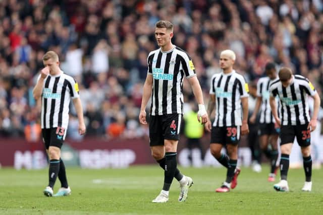 Newcastle United defender Sven Botman, centre, and his team-mates after the final whistle at Villa Park.