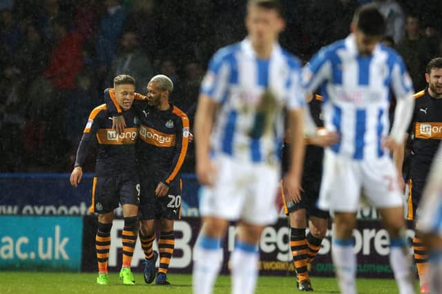Dwight Gayle celebrates scoring United's third in the weekend win over Huddersfield.