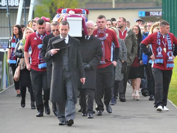 The coffin of 10-year-old Jak Fada is carried into Mariners Park.