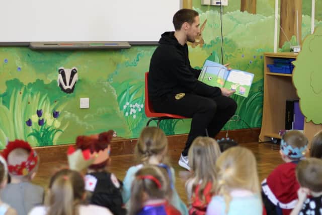 Jon Shaw reads to pupils