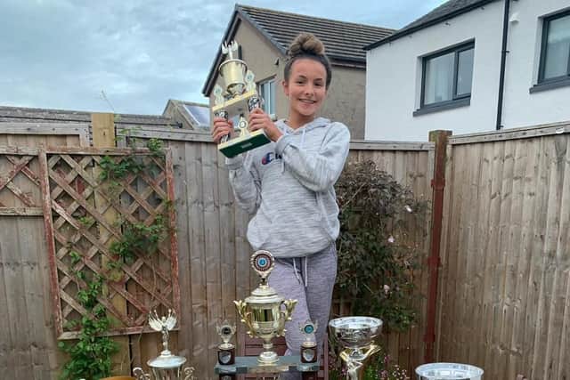 Holly Skiggs at home in South Shields, with some of her dance trophies