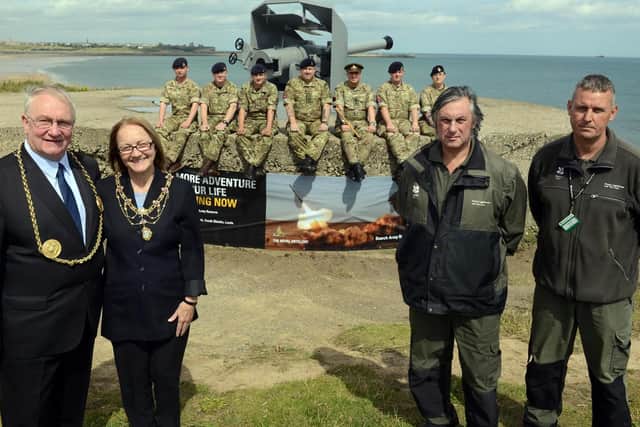 Disappearing Gun on Trow Rock after it was restored by 205 battery with paint materials supplied by National Trust, in 2015. 
Former Mayor and Mayoress Richard and Patricia Porthouse and National Trust's Mick Simpson and Dougie Holden.