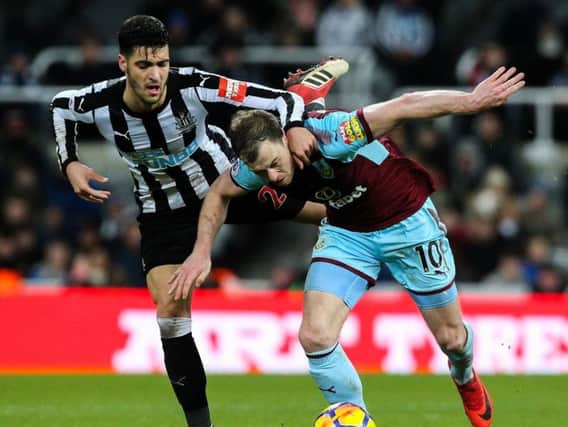 Mikel Merino tussles with Ashley Barnes, of Burnley.