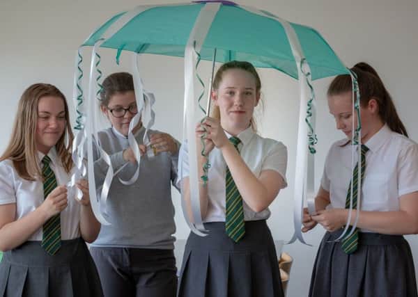 Year 8 students from St Wilfrid's R.C College with their artwork at the Deeds not Words event. Photo by David Wood.