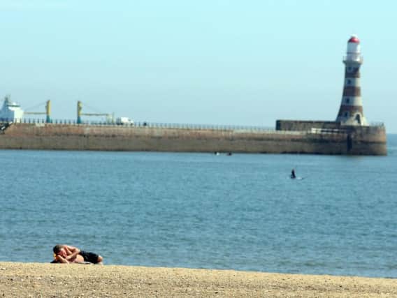 A sunbather relaxes at Roker Beach in Sunderland.