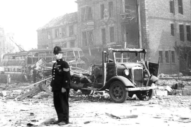 A policeman stands among the rubble left in South Shields Market Place following a German air raid in 1941.