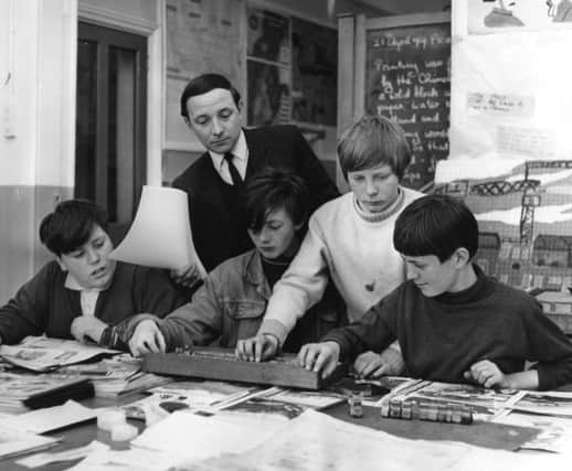 Ocean  Road School teacher Ron Thornton with pupils, left to right,  Neil Martin, Freddy Webb, Neil Blackburn and David Owen. They appear to be creating their own newspaper after a study of the Shields Gazette.