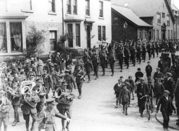 A parade passing  Bollinbroke Street Drill Hall during the First World War.