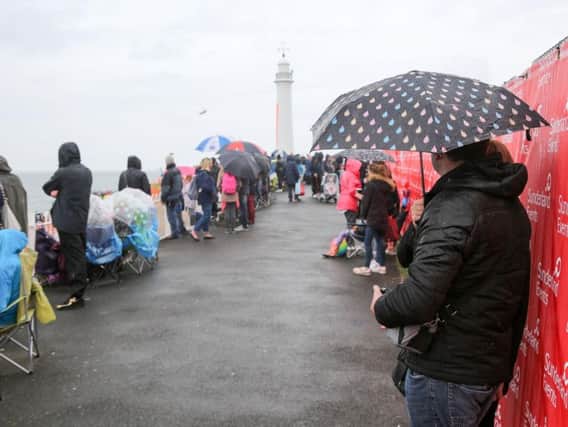 Spectators shelter from the rain at last year's airshow.