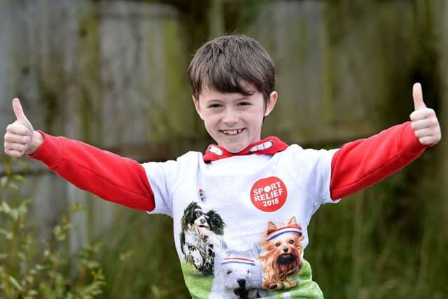 Daniel Rowell (8) at the end of his 100 mile walk in aid of Sports Relief. Picture by Frank Reid