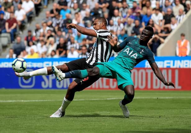 Salomon Rondon is challenged by Tottenham Hotspur's Davinson Sanchez.