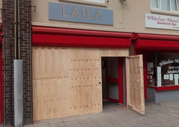The front the of the Laila salon, which has been boarded up following the van attack.