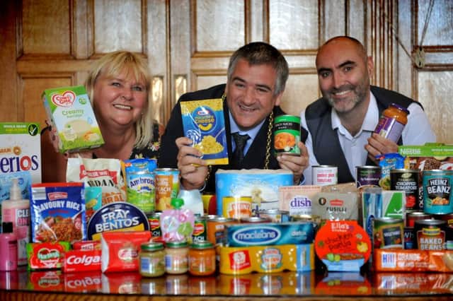 Unison Branch Secretary Janet Green, South Tyneside Mayor Coun Ken Stephenson and Paul Oliver, of HospitalityÂ and Hope, pictured with items donated to food banks in South Tyneside.