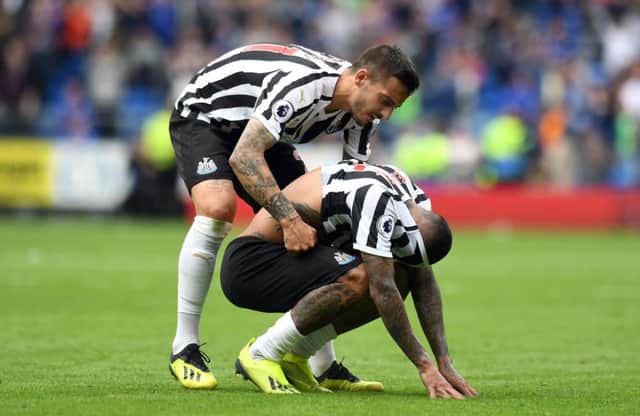 Newcastle United's Kenedy is consoled by Joselu after missing the last-minute penalty.