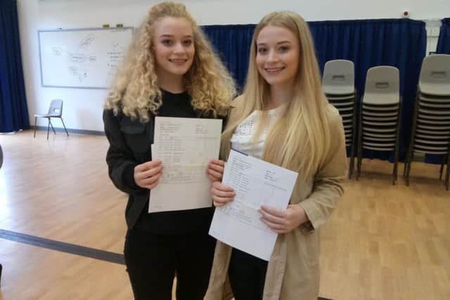 Twins Jessica and Hannah Holman celebrate their results.