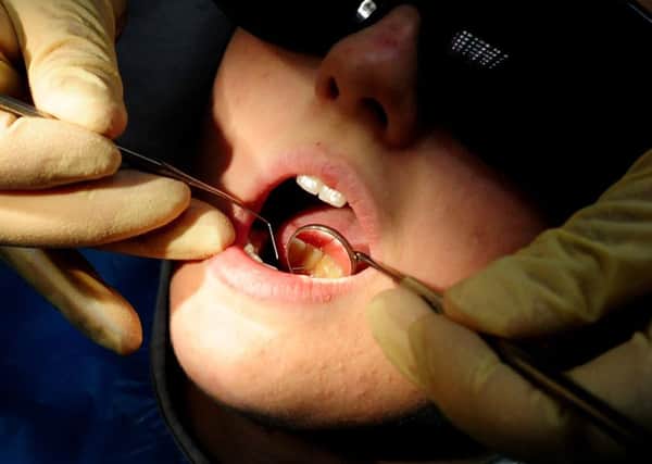 A dentist checking a child's teeth. Picture PA Wire/PA Images