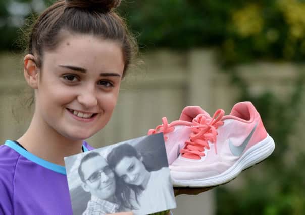 Eli Jo House with her running shoes and a photograph of her late dad Matt Fryer.