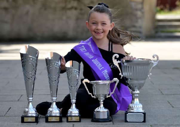 Dancer Iyla Scroggins with her trophies.